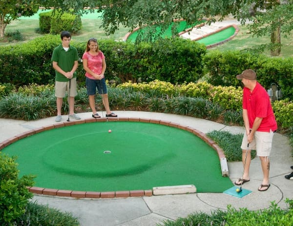 Small family playing mini golf at Coconut Creek!