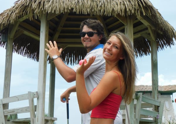 An image of a couple saying hi from Coconut Beach mini-golf in Panama City Beach, Florida!