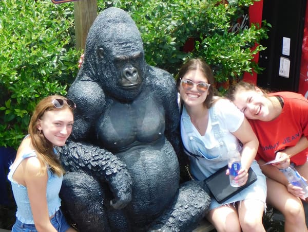 An image of 3 girls posing with our gorilla at Coconut Creek Family Fun Park in Panama City Beach, Florida.