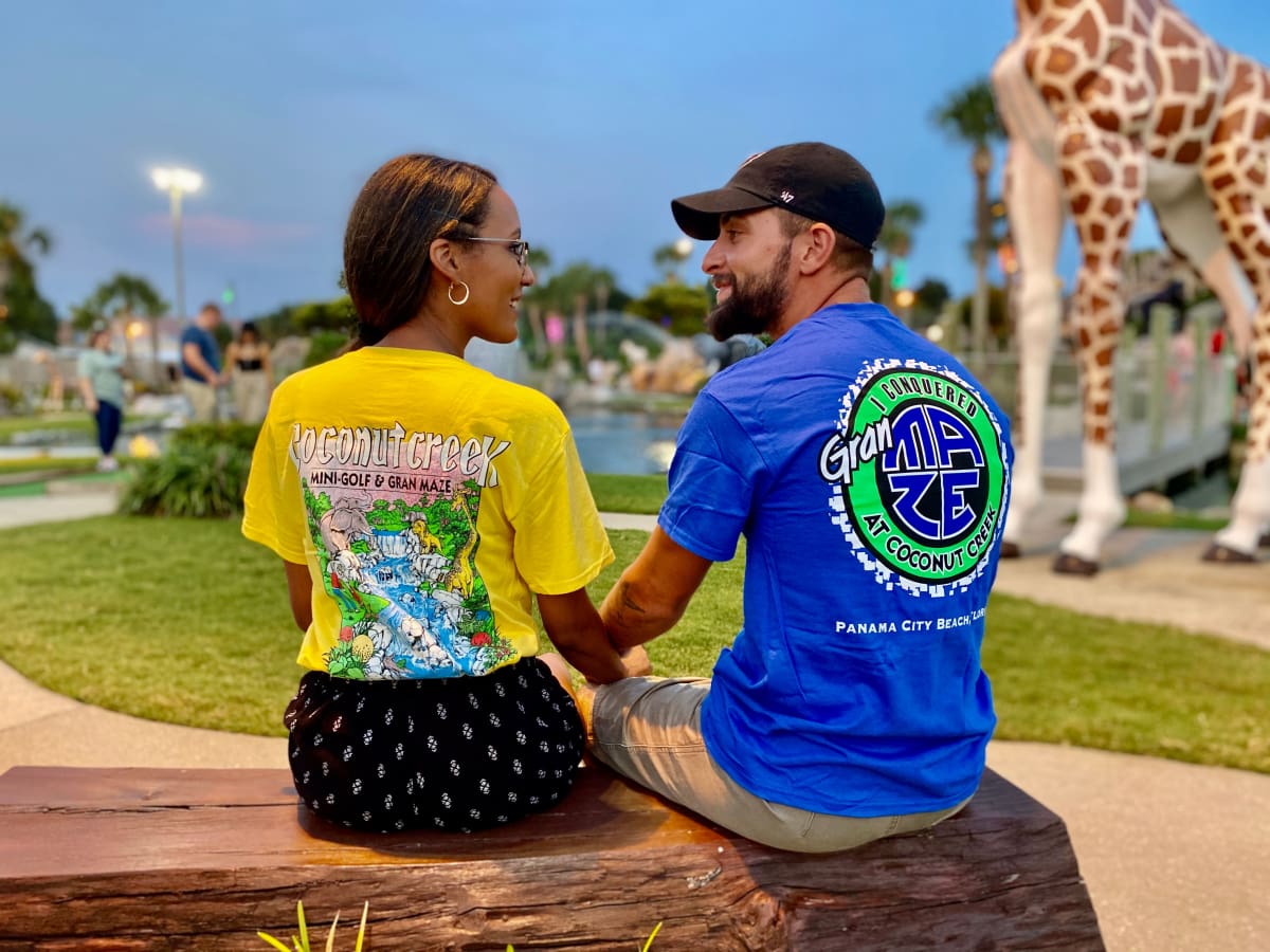 Image of a couple showing off Coconut Creek T-shirts.